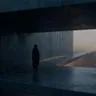 A cinematic, fine-art photograph of a lone, shadowed figure in a brutalist concrete structure at twilight. A narrow bridge of light crosses a vast void toward a distant, hazy horizon. Dark charcoals and blues dominate, accented by a soft, warm amber glow. Film grain and soft-focus effects create a melancholic, transitional mood.
