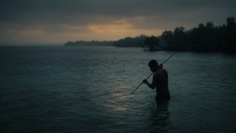 A lone fisherman standing in dark still water at dusk, waiting without a catch — a metaphor for the cold start problem in personalization