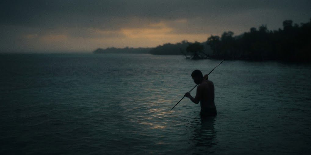 A lone fisherman standing in dark still water at dusk, waiting without a catch — a metaphor for the cold start problem in personalization